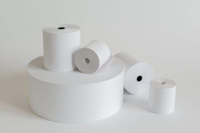 Roll of cash register tape isolated on soft gray background.High resolution photo.